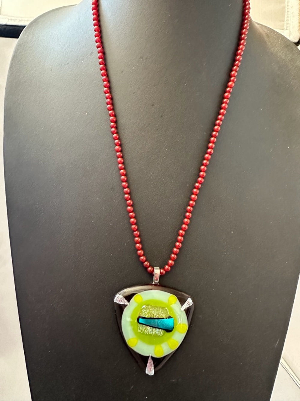 Art glass triangular pendant on handmade carnelian bead necklace